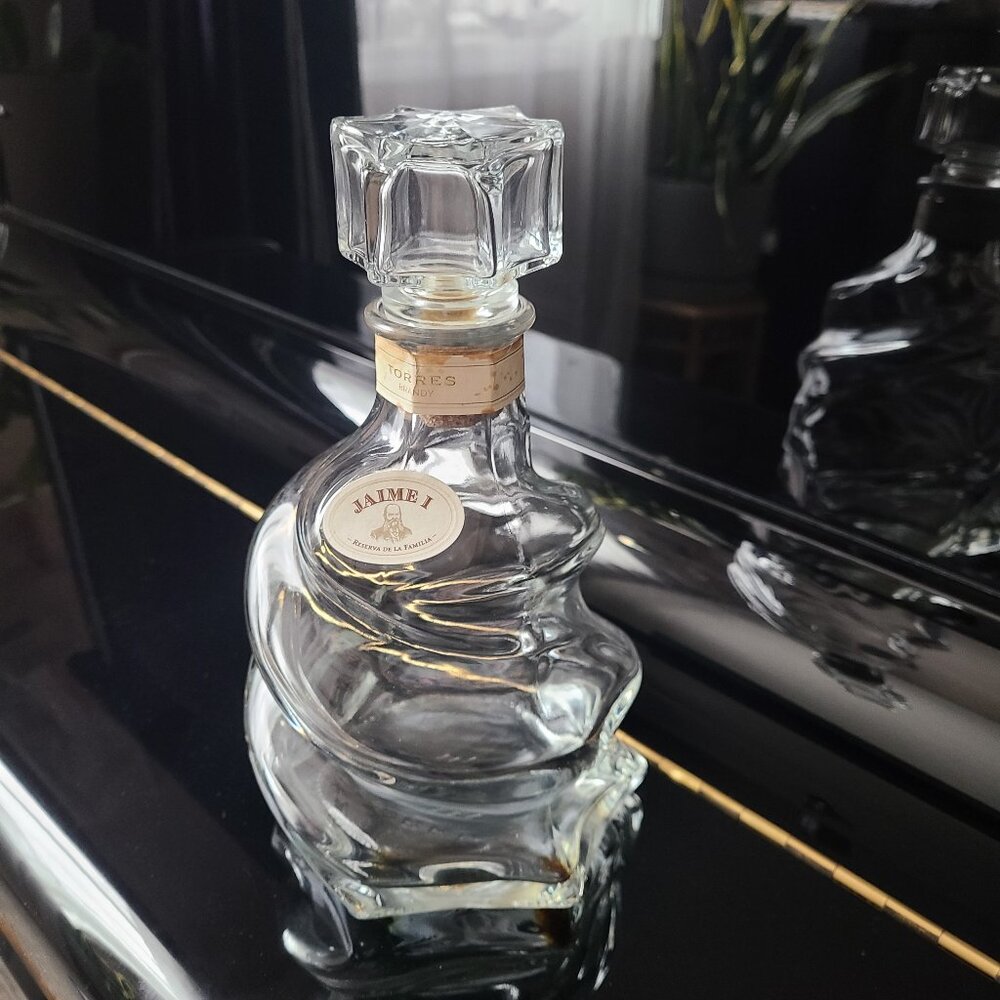 Torres brandy Jaime clear glass swirl empty bottle with stopper.